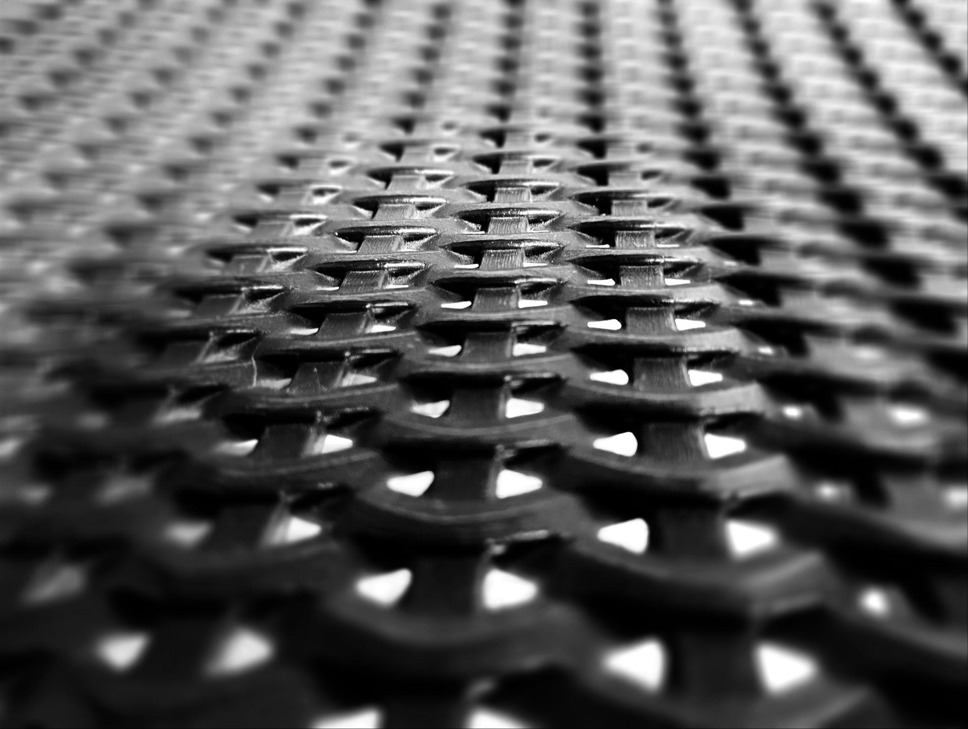 a black and white photo of a metal grate